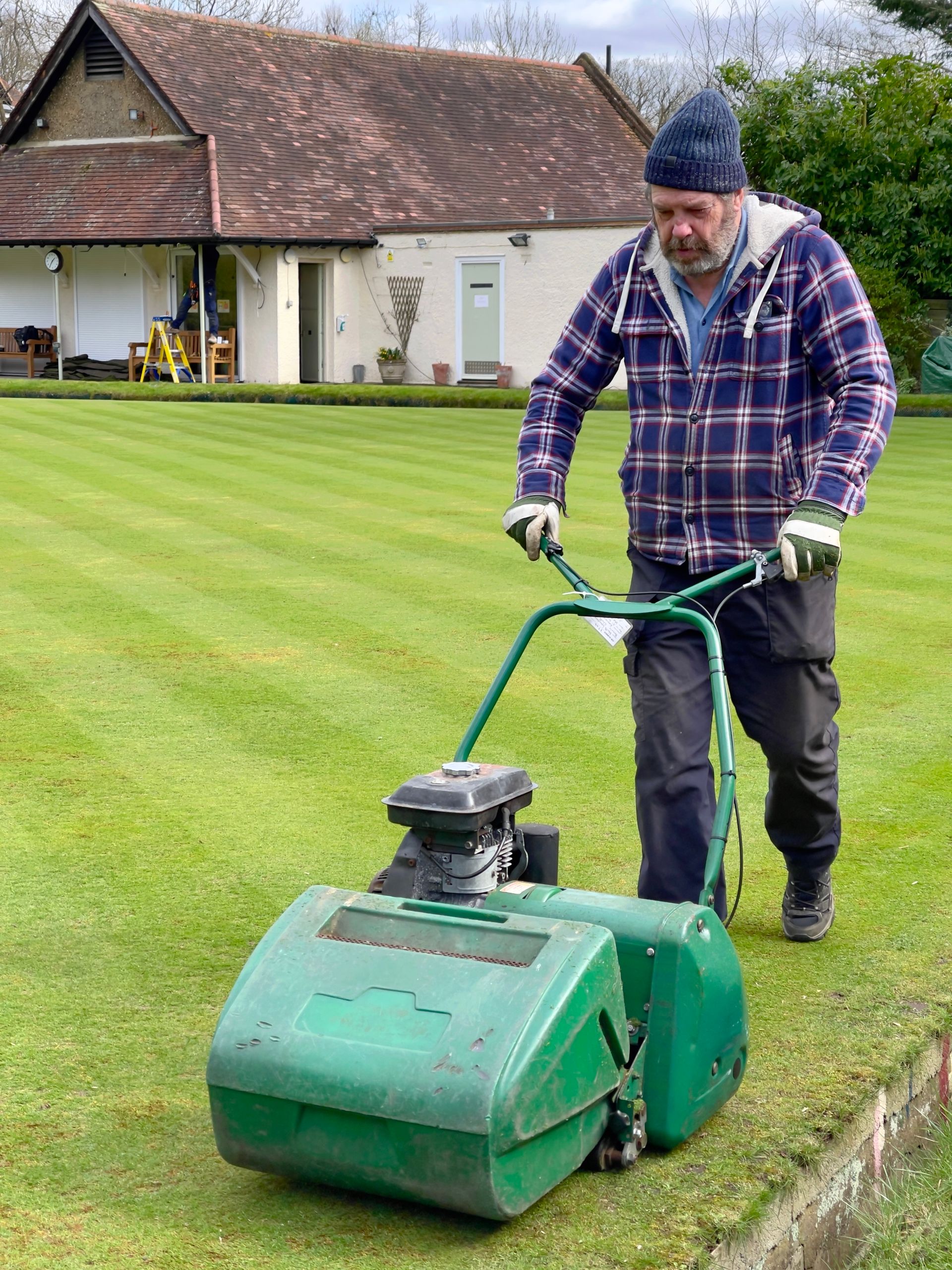 Mowing a residential lawn with even, straight mowing stripes